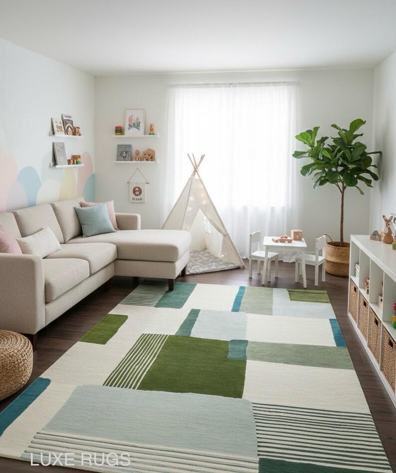 May include: A modern living room with a beige sectional sofa, a geometric patterned rug in shades of green, blue, and white, and a small teepee. The room is decorated with shelves, a small table and chairs, and a potted plant.