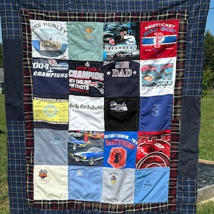 May include: A handmade quilt featuring a patchwork design with various squares. The squares display images and text, including "USS HUNLEY", "EARNHARDT", "PAWTUCKET RED SOX", and "CHAMPIONS". The quilt has a blue plaid border and a dark blue backing.