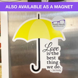 May include: Yellow umbrella magnet with the quote "Love is the best thing we do." - Ted Mosby. The magnet is on a silver refrigerator.