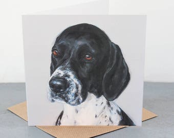 May include: A black and white dog with a white spot on its nose. The dog has black fur and white spots. The dog is looking to the left of the image.
