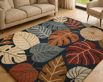 May include: A rectangular area rug with a dark blue background and large leaf patterns in shades of brown, beige, and blue. The rug is placed on a hardwood floor, and the text "HOMERUGSGIFTS" is visible on the rug.