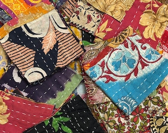 May include: A collection of colorful, square fabric patches with intricate stitching. The patches feature various patterns, including floral designs, geometric shapes, and abstract motifs. The color palette includes red, blue, yellow, and black.