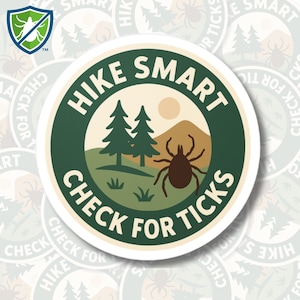 May include: A round sticker with the text "HIKE SMART CHECK FOR TICKS" in white on a dark green border. The center features a landscape with two pine trees, a mountain, and a tick illustration. A shield logo with a tick is in the upper left.