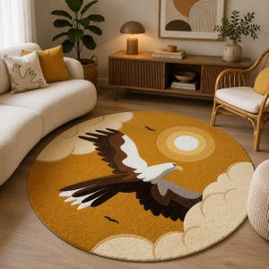 Puede incluir: Una alfombra circular con fondo amarillo mostaza que muestra un gran águila en vuelo. El águila tiene plumas marrones, blancas y grises. El diseño incluye nubes de color crema en los bordes y un sol circular en la esquina superior derecha.