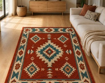 May include: A rectangular area rug featuring a vibrant rust-orange background with a geometric pattern in shades of teal, cream, and brown. The design includes a large central diamond motif surrounded by smaller diamond shapes and borders.