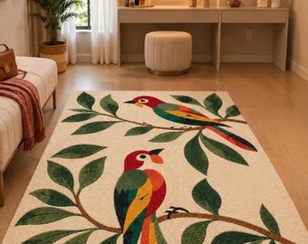 May include: A rectangular area rug with a cream-colored background featuring two colorful parrots perched on brown branches with dark green leaves. The parrots have red heads, white faces, and wings with vibrant yellow, green, and red plumage.