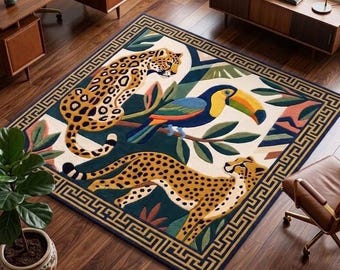May include: A rectangular area rug featuring a central design of two spotted leopards and a toucan perched on a branch amidst green foliage. The rug has a cream-colored background and a dark blue border with a repeating geometric Greek key pattern.