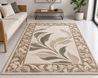 May include: A rectangular area rug featuring a cream-colored center with a large, embossed-style leaf pattern in shades of sage green and taupe. The border displays a repeating floral and vine motif in matching neutral tones and textures.