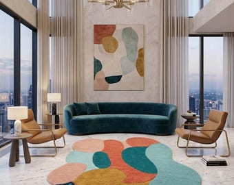 May include: An irregular, organic-shaped area rug featuring a multi-colored abstract pattern of teal, orange, mustard yellow, and pink shapes, including sections with dark blue stripes and dotted textures, placed on a white marble floor.