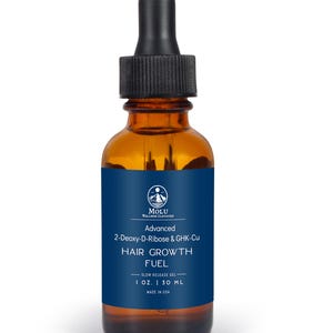 May include: A brown glass bottle with a black dropper, labelled "HAIR GROWTH FUEL." The blue label includes the text "Advanced 2-Deoxy-D-Ribose & GHK-Cu" and "1 OZ. | 30 ML." The product is made in the USA.