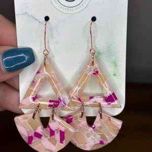 May include: A white ceramic mug with a black handle and the text "But First, Coffee" in a black, handwritten-style font. The mug is on a white surface.