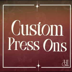 May include: A square graphic with a dark red to orange gradient background featuring the white text Custom Press Ons in a serif font. A thin white border frames the image with a star icon at the top and bottom. The logo HI Gloss is in the corner.