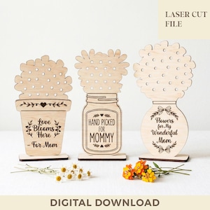 May include: Three wooden laser-cut floral arrangements. One is a flower pot with the text "Love Blooms Here - For Mom." Another is a mason jar with "Hand Picked for Mommy." The last is a vase with "Flowers for My Wonderful Mom."