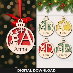 May include: Wooden Christmas ornaments with a reindeer design and personalized names or initials. The ornaments are in the shape of a ball with a red background and a snowflake. The text "DIGITAL DOWNLOAD" is at the bottom.