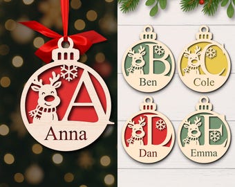 May include: Wooden Christmas ornaments with a reindeer design and personalized names or initials. The ornaments are in the shape of a ball with a red background and a snowflake. The text "DIGITAL DOWNLOAD" is at the bottom.