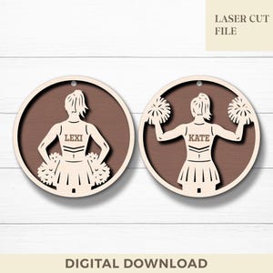 May include: Two wooden laser-cut ornaments depicting cheerleaders. One ornament has the name "LEXI" and the other has "KATE". The ornaments are circular with a brown background and a light-coloured cheerleader design. The text "LASER CUT FILE" and "DIGITAL DOWNLOAD" are also present.