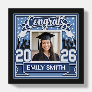 May include: A graduation photo frame with a black border. The frame has a blue and silver design with the word "Congrats" at the top. The year "2026" is displayed on the left and right sides. The name "EMILY SMITH" is displayed at the bottom.