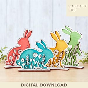 May include: A white ceramic mug with a black handle and the text "But First, Coffee" in a bold, black font. The mug is set against a blurred background, highlighting its clean design.