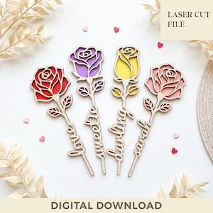 May include: Four laser-cut wooden rose decorations in red, purple, yellow, and pink. Each rose has a stem with leaves and a name: Love, Sweetie, Darling, and Sarah. The words "LASER CUT FILE" and "DIGITAL DOWNLOAD" are also visible.