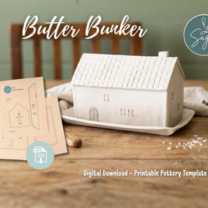 May include: A white ceramic butter dish in the shape of a house, featuring a textured roof and small windows. The words "Butter Bunker" are displayed above the house. The image also includes a digital download of a printable pottery template.
