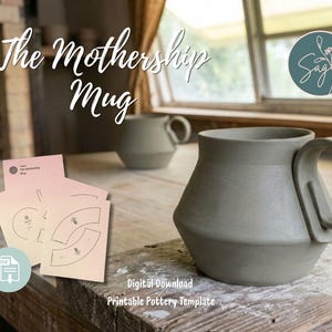 May include: A matte sage green ceramic mug with a wide base and a large handle, accompanied by a set of light pink paper templates featuring black line drawings and the text The Mothership Mug, Digital Download, Printable Pottery Template.