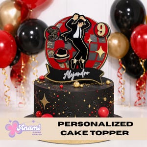 May include: A personalized cake topper featuring a silhouette of a dancer in a black suit, set against a red and gray disco ball design. The cake is black with gold star and dot accents, and the name "Alejandro" is displayed on a banner.