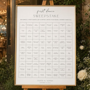May include: A rectangular white sign with a gold frame on a wooden easel. The text reads first dance SWEEPSTAKE, 80 SONGS | 1 FIRST DANCE | $1 TO ENTER | WRITE YOUR NAME | WINNER TAKES ALL, followed by a grid of song titles, OLIVER & SOPHIA, NOVEMBER 19 2024.