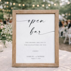 open bar wedding sign in natural wood frame with greenery and outdoor reception background, modern minimalist wedding signage, printable bar sign template, editable Canva wedding decor, garden wedding aesthetic
