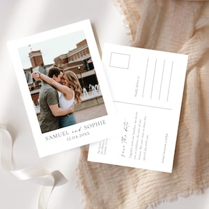 May include: Two white postcards with a photograph of a couple embracing, with the names "SAMUEL and SOPHIE" and the date "12.04.20XX" printed on the front. The back of the postcard has lines for an address and the text "Save the date".
