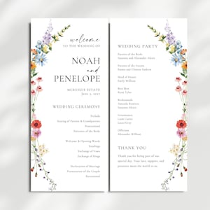 May include: A wedding program with floral accents. The program is white with text in black, including the names "Noah and Penelope" and the date "June 5, 2022." Delicate watercolor flowers in shades of pink, yellow, blue, and purple adorn the edges.