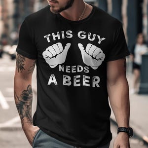 This Guy Needs A Beer T-Shirts, Funny Drinking Tee, Humor Gift, Beer Lover Shirt, Party T Shirt, Graphic T Shirt, Unisex Clothing