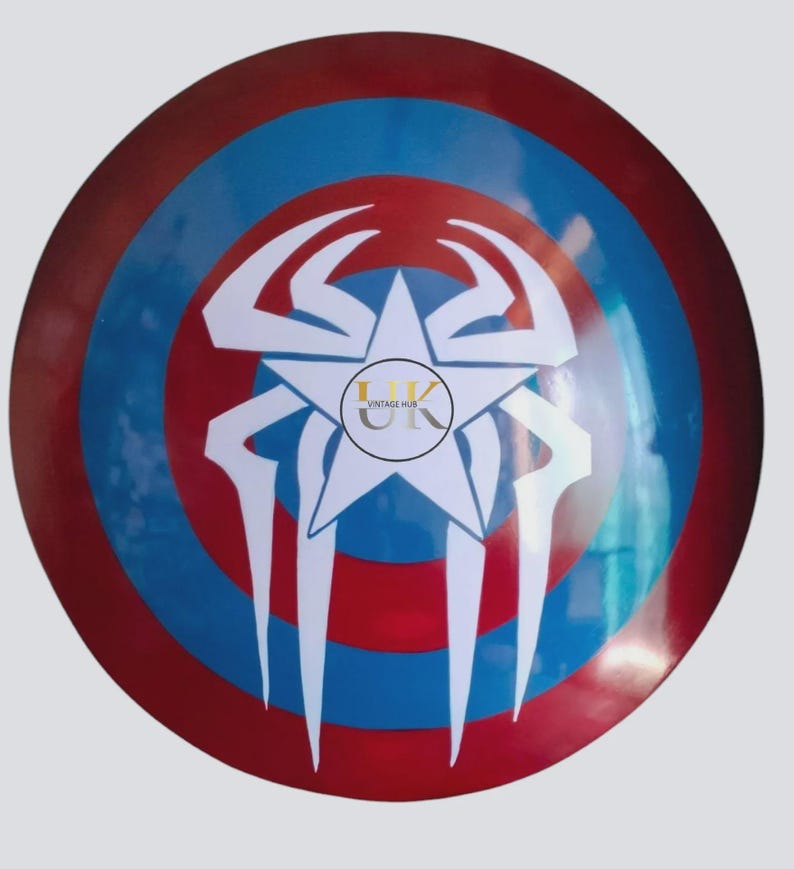 May include: A circular shield in red, white, and blue. It has a white star and a spider web design. The centre of the shield has the text "VINTAGE HUB" in a circle. A decorative item.