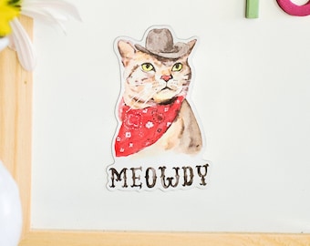 May include: A white background with a brown wooden frame. A cat wearing a cowboy hat and red bandana is on the white background. The cat is looking to the right. The text "MEOWDY" is below the cat. The words "TO DO TODAY" are written in colorful letters on the white background.