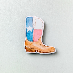 May include: A brown cowboy boot with a white star and red and blue stripes, resembling the Texas flag.