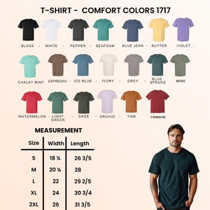 May include: A display of Comfort Colors 1717 t-shirts in various colors, including black, white, and blue jean. The image also shows a measurement chart with sizes ranging from S to 2XL, with width and length measurements in inches. A person is wearing a dark green t-shirt.