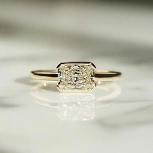 2 CT Radiant Moissanite East-West Ring: 14k Yellow Gold Half Bezel Solitaire