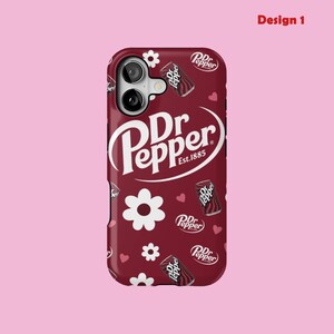 May include: A maroon phone case with a Dr Pepper design. The case features a pattern of white flowers, hearts, and miniature Dr Pepper cans. The Dr Pepper logo is in white, with the text "Est. 1885".