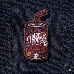 May include: An embroidered patch shaped like a soda can with a straw, featuring a dark red background and the white Dr Pepper logo with Est. 1885 text. The design includes small embroidered Halloween motifs like ghosts, pumpkins, bats, and hats.
