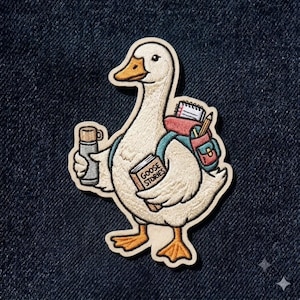 May include: An embroidered patch featuring a white goose with an orange beak and feet. The goose wears a teal backpack containing a notebook and pencil, holds a silver thermos, and carries a brown book with the text GOOSE STORIES on the cover.