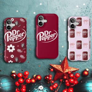 May include: Three phone cases with Dr Pepper branding. One case is solid burgundy, another has a pattern of flowers and Dr Pepper cans, and the third features a pattern of bows and Dr Pepper cans. The cases are on a teal background with holiday decorations.