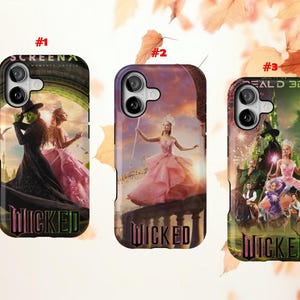 May include: Three phone cases featuring artwork from the musical "Wicked." Each case displays a different scene with characters in elaborate costumes. The word "Wicked" is printed in a stylized font at the bottom of each case.