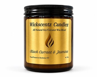 May include: A brown glass candle jar with a black screw-top lid and a gold label. The label features the text Wickscentz Candlez, All Natural Soy/Coconut Wax Blend, Black Currant & Jasmine, Hand Poured in Rochester NY, and wt. 9oz.