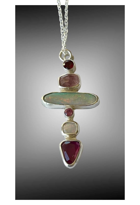 Multiple stone cross pendant