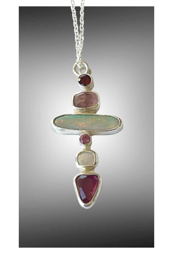 Multiple stone cross pendant