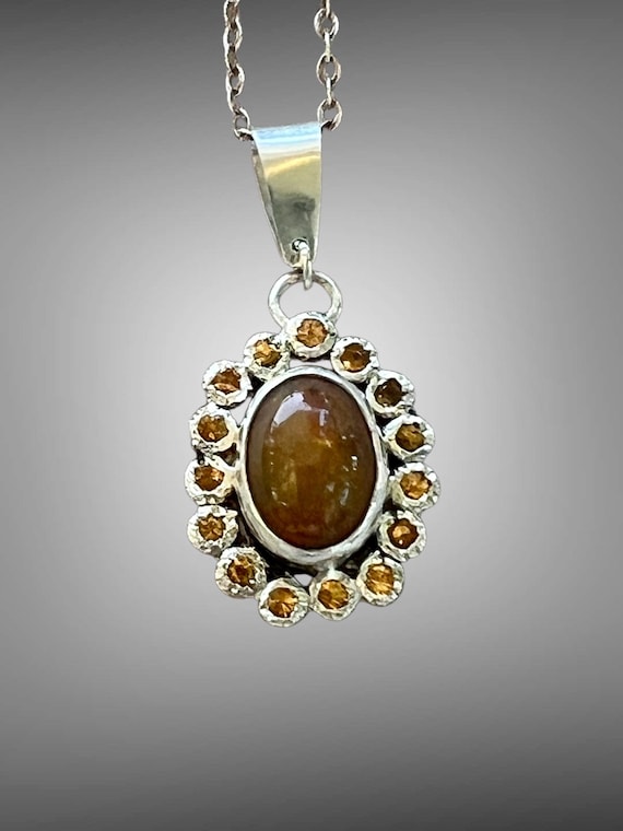 Ethiopian opal surrounded by spressarite garnets pendant