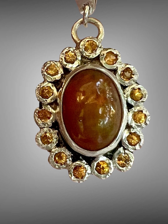 Ethiopian opal surrounded by spressarite garnets pendant