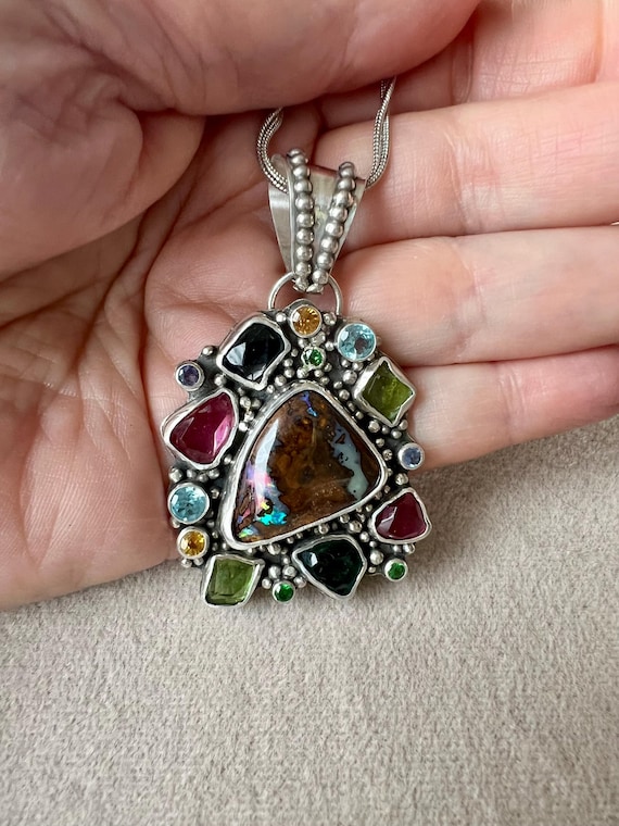 Boulder opal surrounded by multiple gem stones pendant