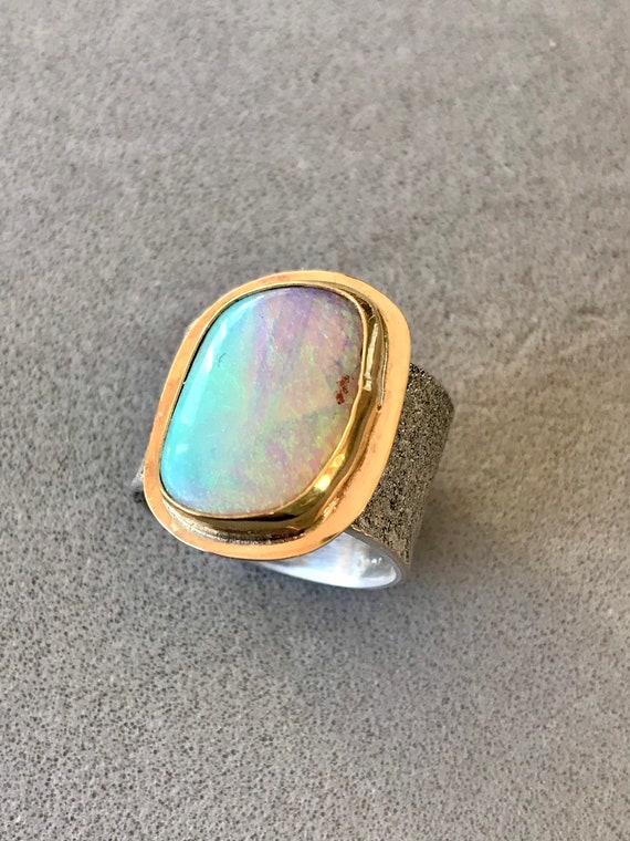 Large crystal opal ring framed with yellow gold