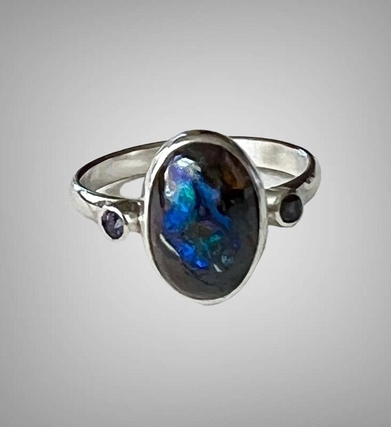 Boulder opal with purple sapphire ring