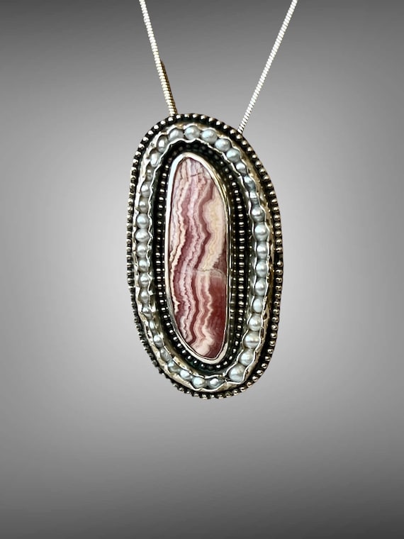 Rhodochrosite wrapped in fresh water pearls a beaded silver frame pendant